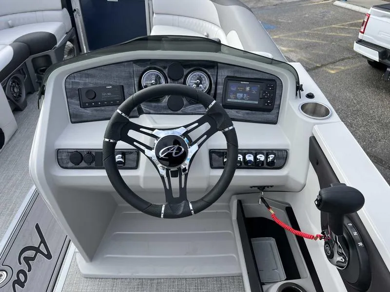 Slide: The Image of 2024 Avalon 2385 25 LSZ Fish RF boat dashboard with steering wheel and control panel. - 6