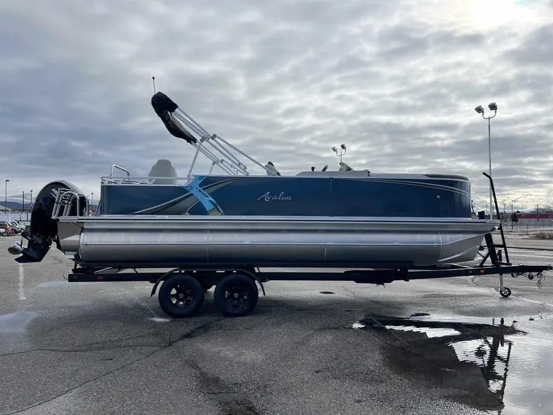 Slide: The Image of 2024 Avalon 2385 25 LSZ Fish RF pontoon boat on trailer in parking lot. - 8