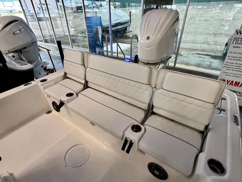 Slide: The Image of 2024 Sea Fox 251 Bay boat with white cushioned seating and Yamaha outboard motor. - 11