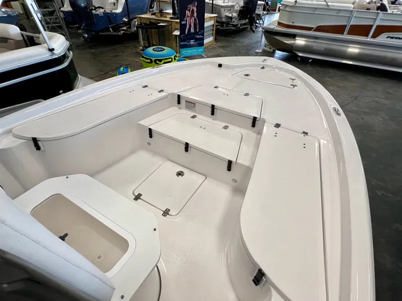 Slide: The Image of 2024 Sea Fox 251 Bay boat interior, spacious deck with storage compartments. - 9