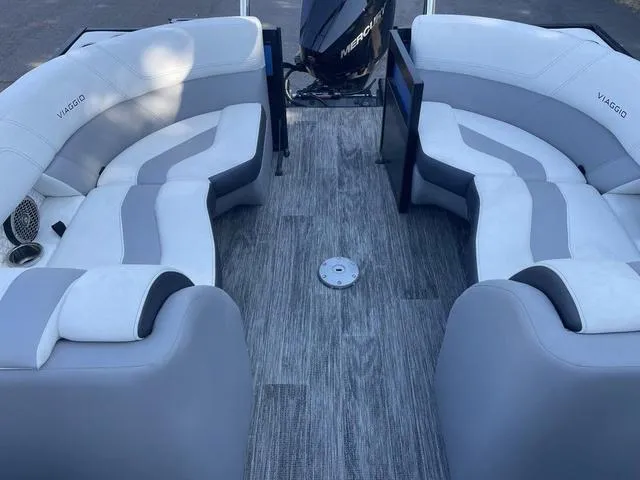 Slide: The Image of Viaggio D23U 2022 boat interior with gray and white seating, Mercury engine in background. - 10