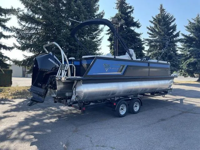 Slide: The Image of 2022 Viaggio D23U pontoon boat on a trailer, parked outdoors. - 3