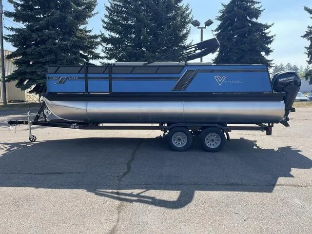 Slide: The Image of 2023 Viaggio L20F pontoon boat on a trailer in a parking lot. - 7