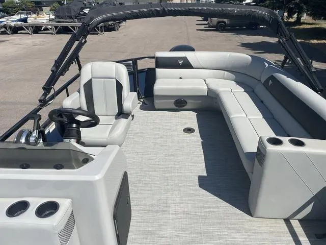 Slide: The Image of 2023 Viaggio DM20C pontoon boat interior with spacious seating and helm station. - 10