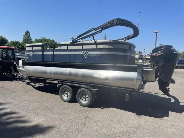 Slide: The Image of 2023 Viaggio DM20C pontoon boat on a trailer with a Mercury outboard motor. - 3