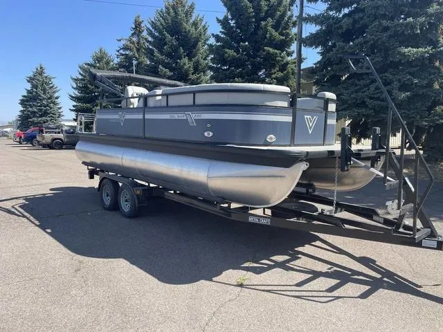 Slide: The Image of 2023 Viaggio DM20C pontoon boat on a trailer in a parking lot. - 7