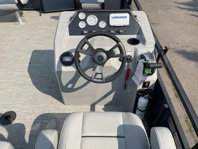 Slide: The Image of Viaggio DM18F 2023 boat dashboard with steering wheel, gauges, and Lowrance device. - 12