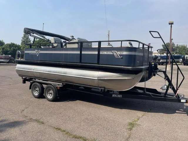 Slide: The Image of 2023 Viaggio DM18F pontoon boat on a trailer in a parking lot. - 3