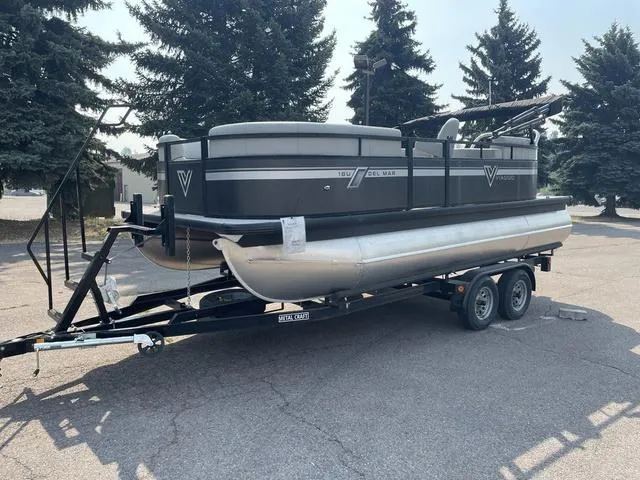 Slide: The Image of 2023 Viaggio DM18U pontoon boat on a trailer in a parking lot. - 1