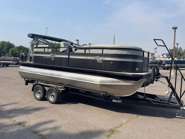 Slide: The Image of 2023 Viaggio DM18U pontoon boat on a trailer in a parking lot. - 3