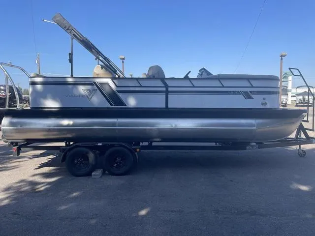 Slide: The Image of 2023 Viaggio L22Q pontoon boat on a trailer in a parking lot. - 4