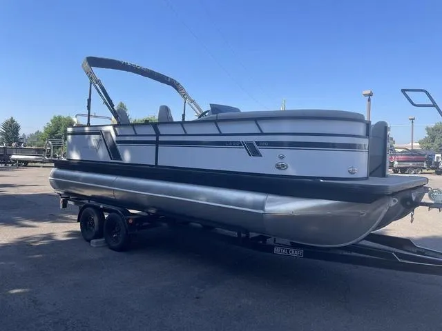 Slide: The Image of 2023 Viaggio L22Q pontoon boat on trailer in outdoor setting. - 6