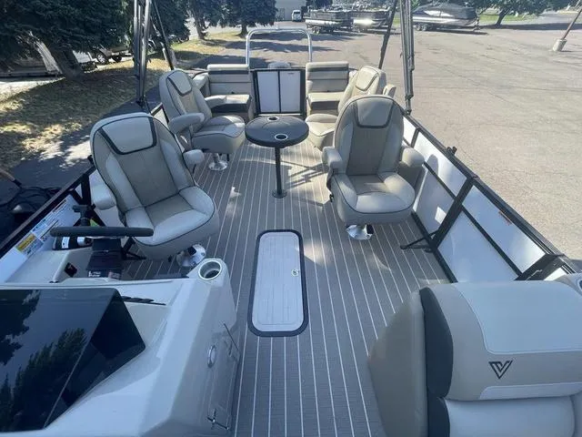 Slide: The Image of 2023 Viaggio L22Q pontoon boat interior with luxurious seating and table. - 8