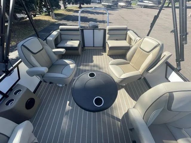 Slide: The Image of 2023 Viaggio L22Q pontoon boat interior with beige seating and round table. - 9
