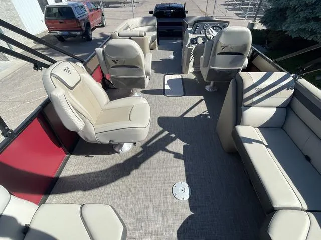 Slide: The Image of 2023 Viaggio L22T pontoon boat interior with beige seating and modern dashboard. - 10