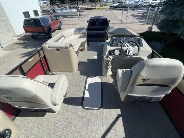 Slide: The Image of 2023 Viaggio L22T pontoon boat interior with beige seating and steering console. - 11