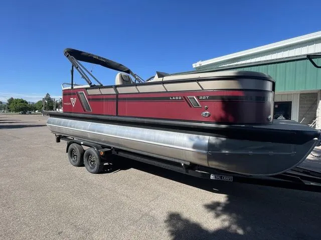 Slide: The Image of 2023 Viaggio L22T pontoon boat on a trailer, red and silver exterior. - 6