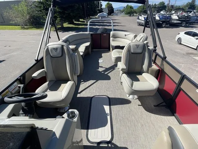 Slide: The Image of 2023 Viaggio L22T pontoon boat interior with beige seating and red side panels. - 8