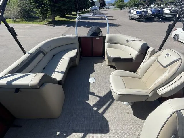 Slide: The Image of 2023 Viaggio L22T pontoon boat interior with beige seating and spacious layout. - 9