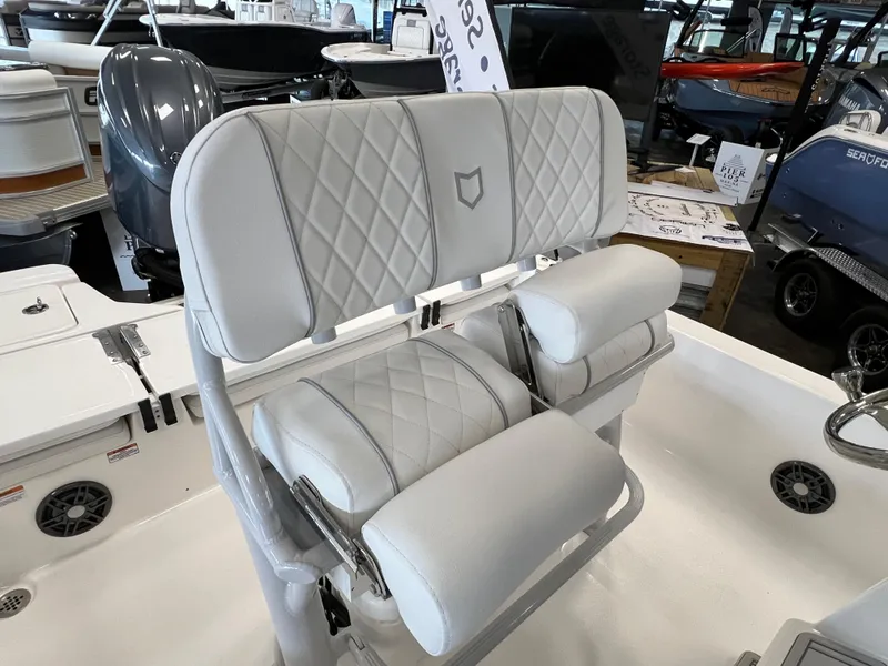 Slide: The Image of 2024 Sea Fox 231 Bay boat with cushioned seating and diamond-stitched upholstery. - 13