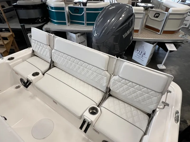 Slide: The Image of 2024 Sea Fox 231 Bay boat with white cushioned seating and Yamaha outboard motor. - 14