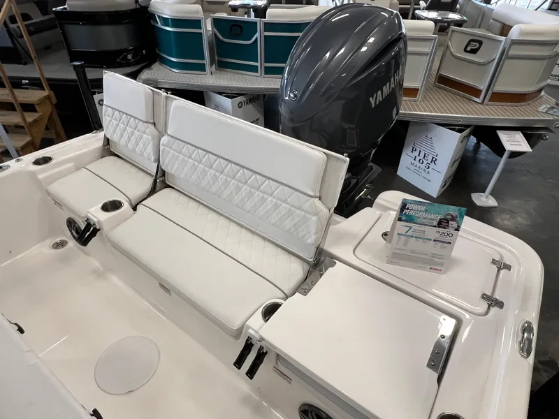 Slide: The Image of 2024 Sea Fox 231 Bay boat with Yamaha engine, white seating, and storage compartments. - 15