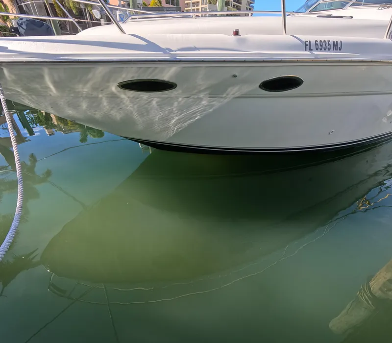 Slide: The Image of 1995 Sea Ray 370 Sundancer boat docked in calm water. - 10