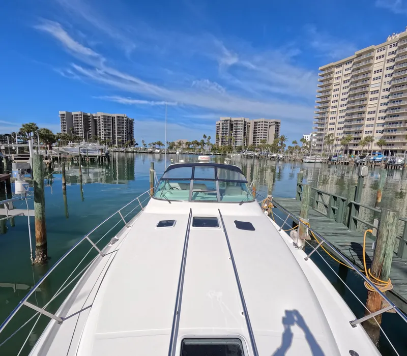 Slide: The Image of 1995 Sea Ray 370 Sundancer docked in a marina with high-rise buildings in the background. - 14