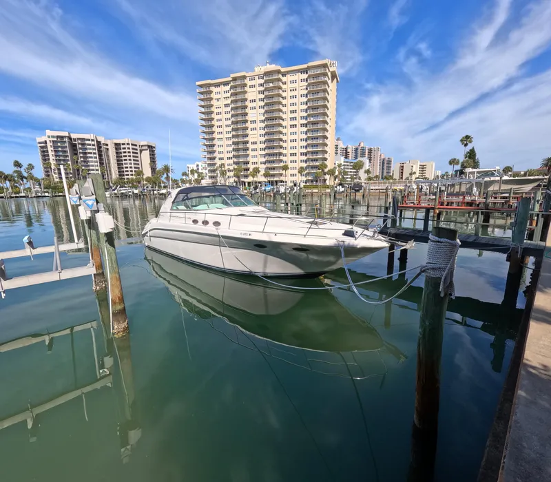 Slide: The Image of 1995 Sea Ray 370 Sundancer docked at marina with high-rise buildings in background. - 18