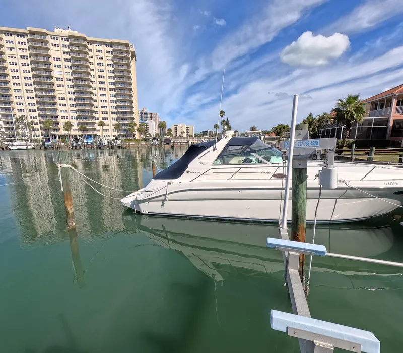 Slide: The Image of 1995 Sea Ray 370 Sundancer docked in a marina with waterfront buildings. - 21