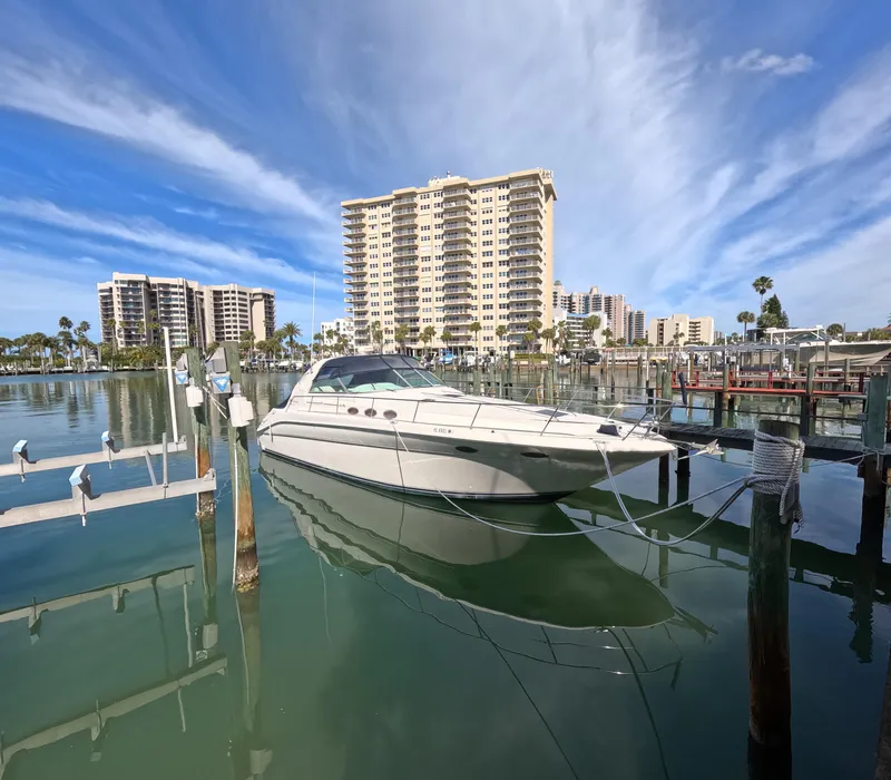 Slide: The Image of 1995 Sea Ray 370 Sundancer docked in a marina with high-rise buildings in the background. - 22
