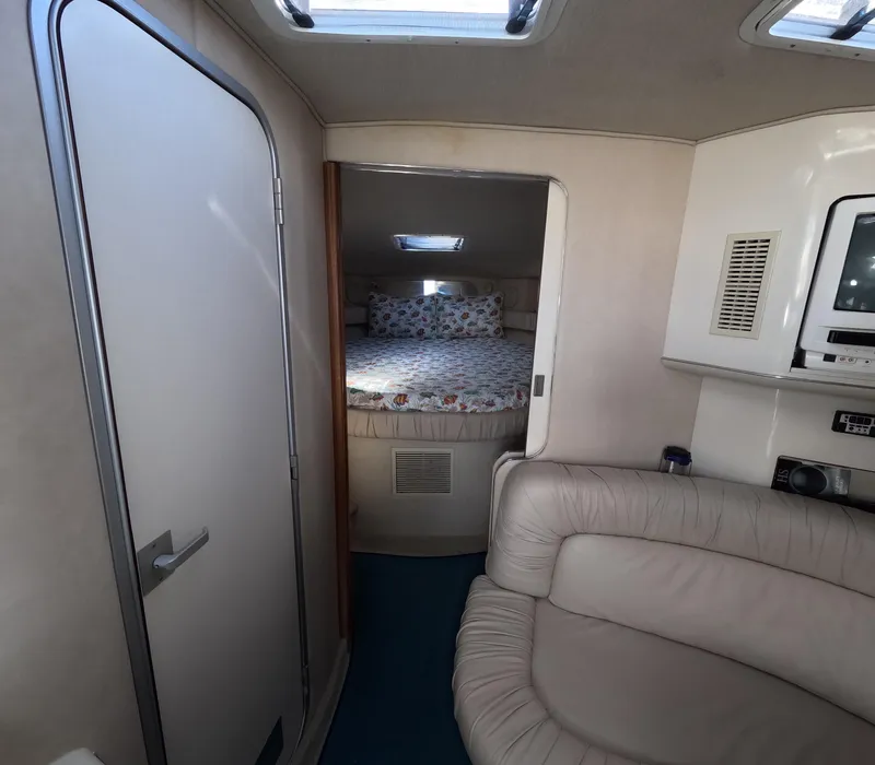 Slide: The Image of Interior cabin of 1995 Sea Ray 370 Sundancer with bed and seating area. - 24