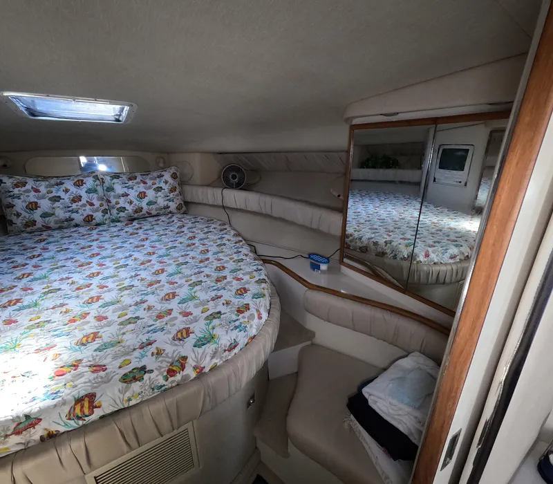 Slide: The Image of Cozy bedroom in 1995 Sea Ray 370 Sundancer with round bed and mirrored closet. - 25