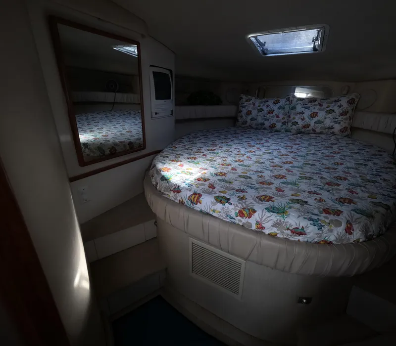 Slide: The Image of Interior cabin of 1995 Sea Ray 370 Sundancer with round bed and floral bedding. - 26