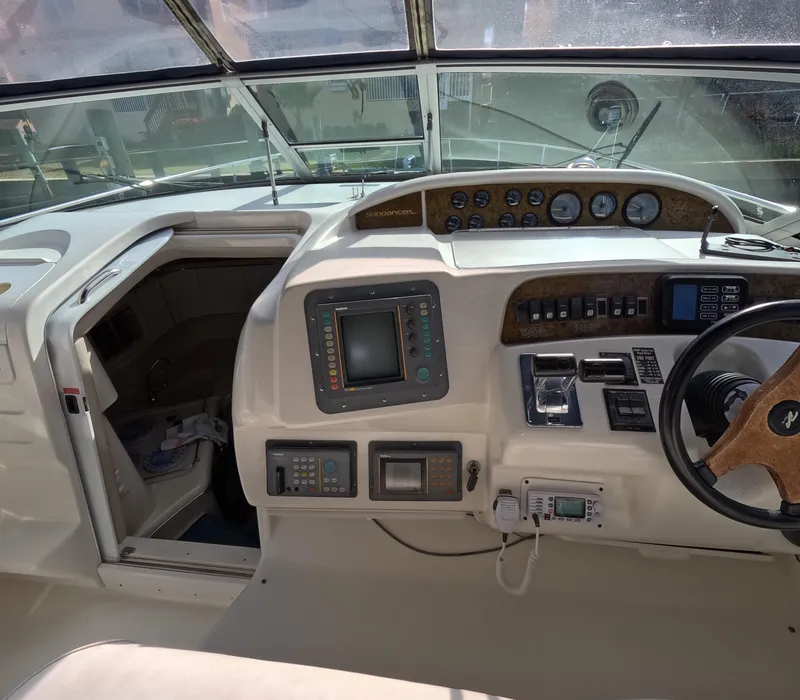 Slide: The Image of 1995 Sea Ray 370 Sundancer helm with navigation instruments and steering wheel. - 3