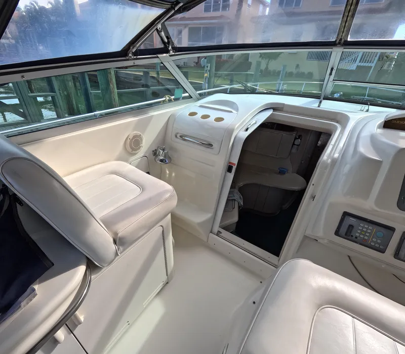 Slide: The Image of Interior cockpit of 1995 Sea Ray 370 Sundancer with white seating and control panel. - 37