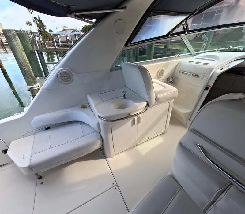 Slide: The Image of Interior of 1995 Sea Ray 370 Sundancer boat with white seating and sink. - 39