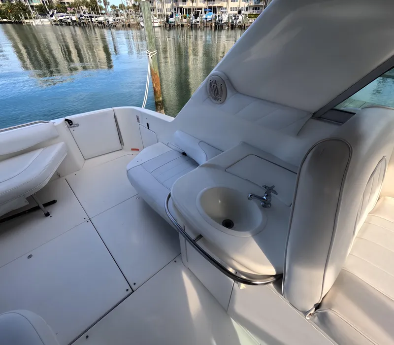 Slide: The Image of 1995 Sea Ray 370 Sundancer boat interior with seating and sink, docked at marina. - 43