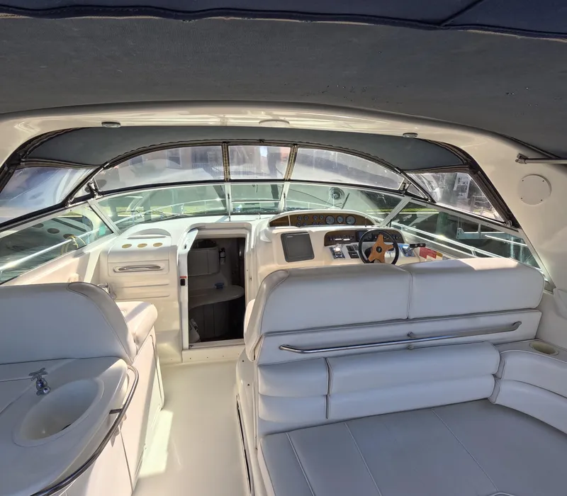 Slide: The Image of Interior of 1995 Sea Ray 370 Sundancer yacht with white seating and helm. - 47