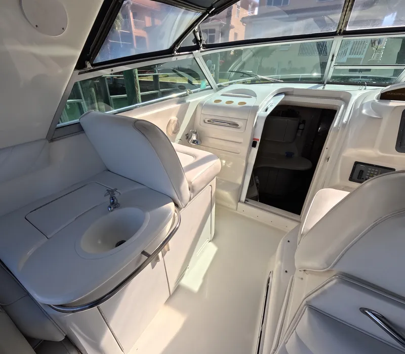 Slide: The Image of Interior of 1995 Sea Ray 370 Sundancer boat with helm, seating, and sink. - 48