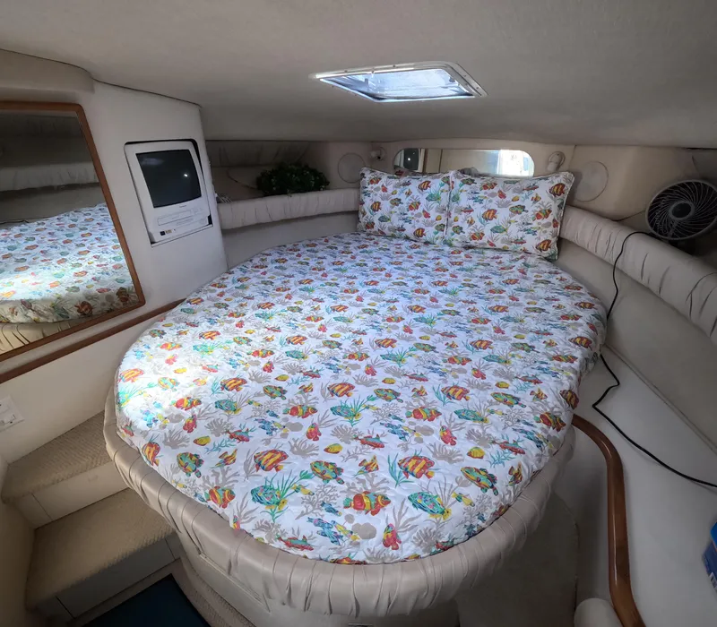 Slide: The Image of Interior cabin of 1995 Sea Ray 370 Sundancer with floral bedding and built-in TV. - 6