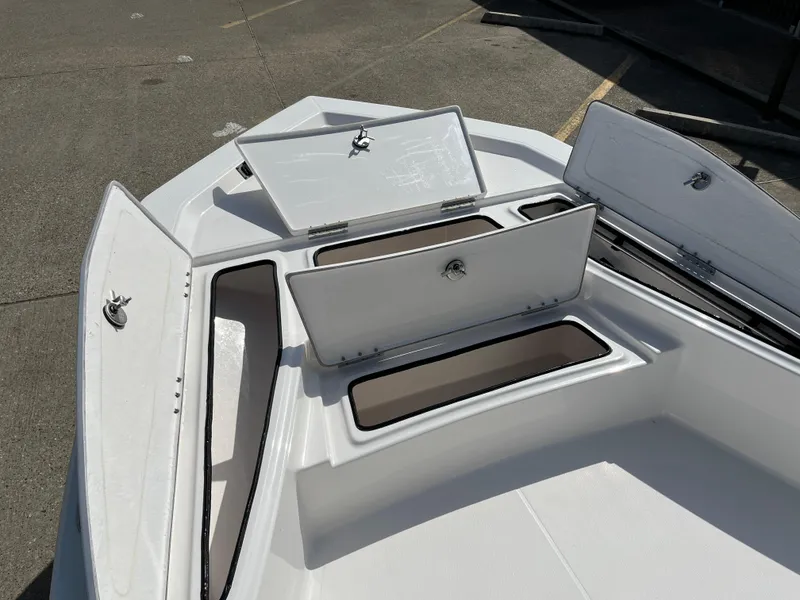 Slide: The Image of 2023 Blue Wave 2200 STL boat with open storage compartments. - 10