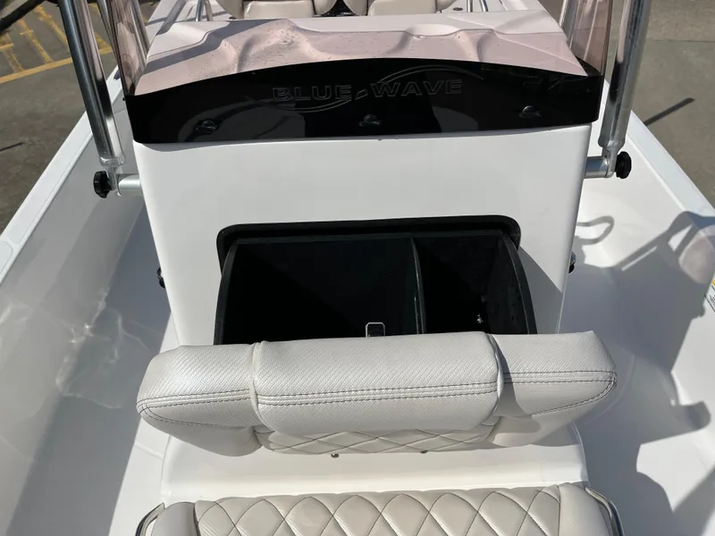 Slide: The Image of 2023 Blue Wave 2200 STL boat interior with storage compartment and cushioned seating. - 12