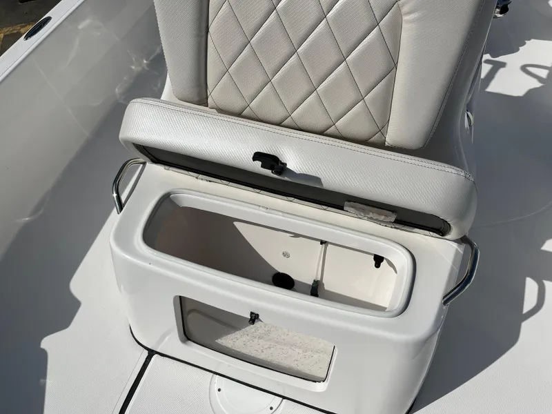 Slide: The Image of 2023 Blue Wave 2200 STL boat with open storage compartment under cushioned seat. - 13