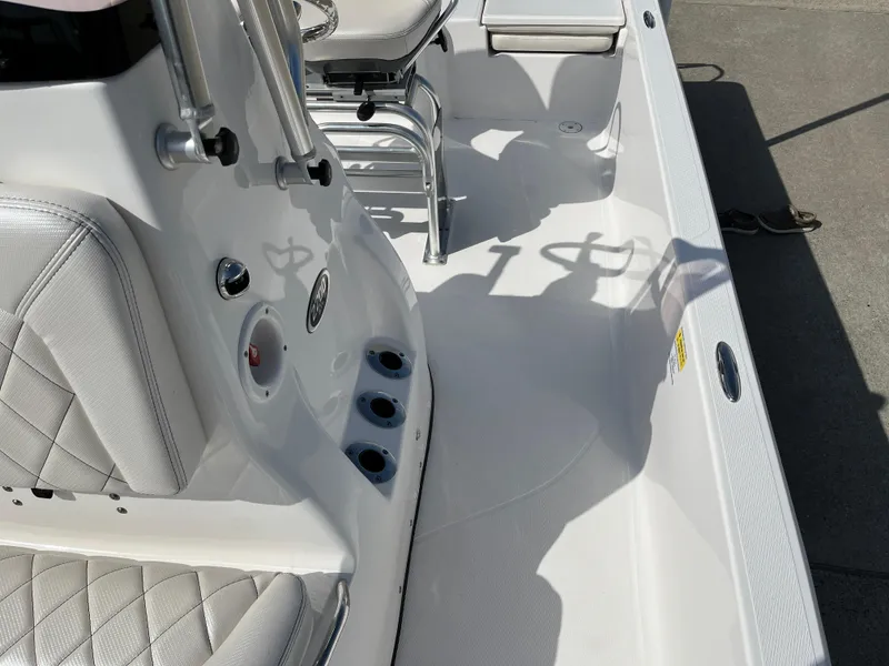 Slide: The Image of 2023 Blue Wave 2200 STL boat interior with white seating and rod holders. - 14