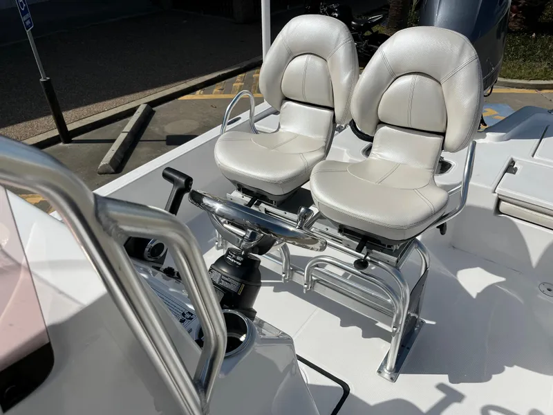 Slide: The Image of 2023 Blue Wave 2200 STL boat with dual white captain's chairs. - 17