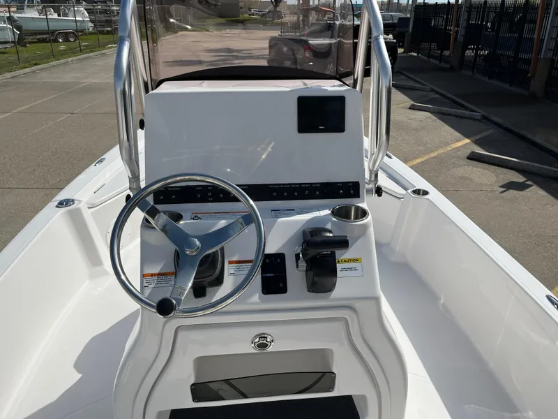 Slide: The Image of 2023 Blue Wave 2200 STL boat console with steering wheel and controls. - 18