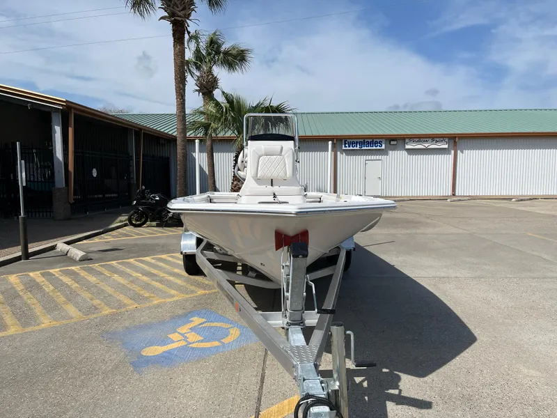 Slide: The Image of 2023 Blue Wave 2200 STL boat on trailer in parking lot. - 2