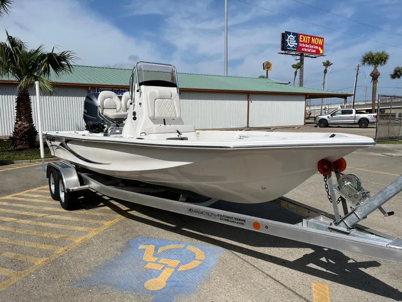 Slide: The Image of 2023 Blue Wave 2200 STL boat on a trailer in a parking lot. - 3