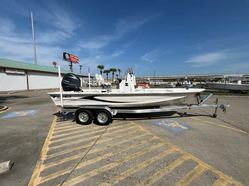 Slide: The Image of 2023 Blue Wave 2200 STL boat on a trailer in a parking lot. - 4